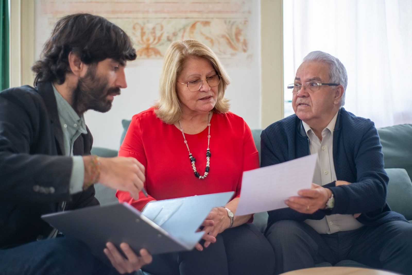 A couple reviewing documents with an advisor.