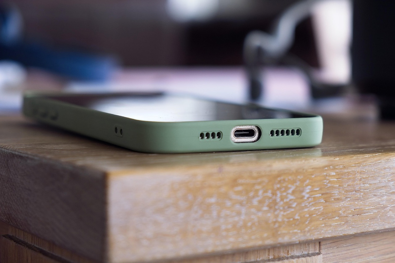Smartphone lying on the edge of a wooden table