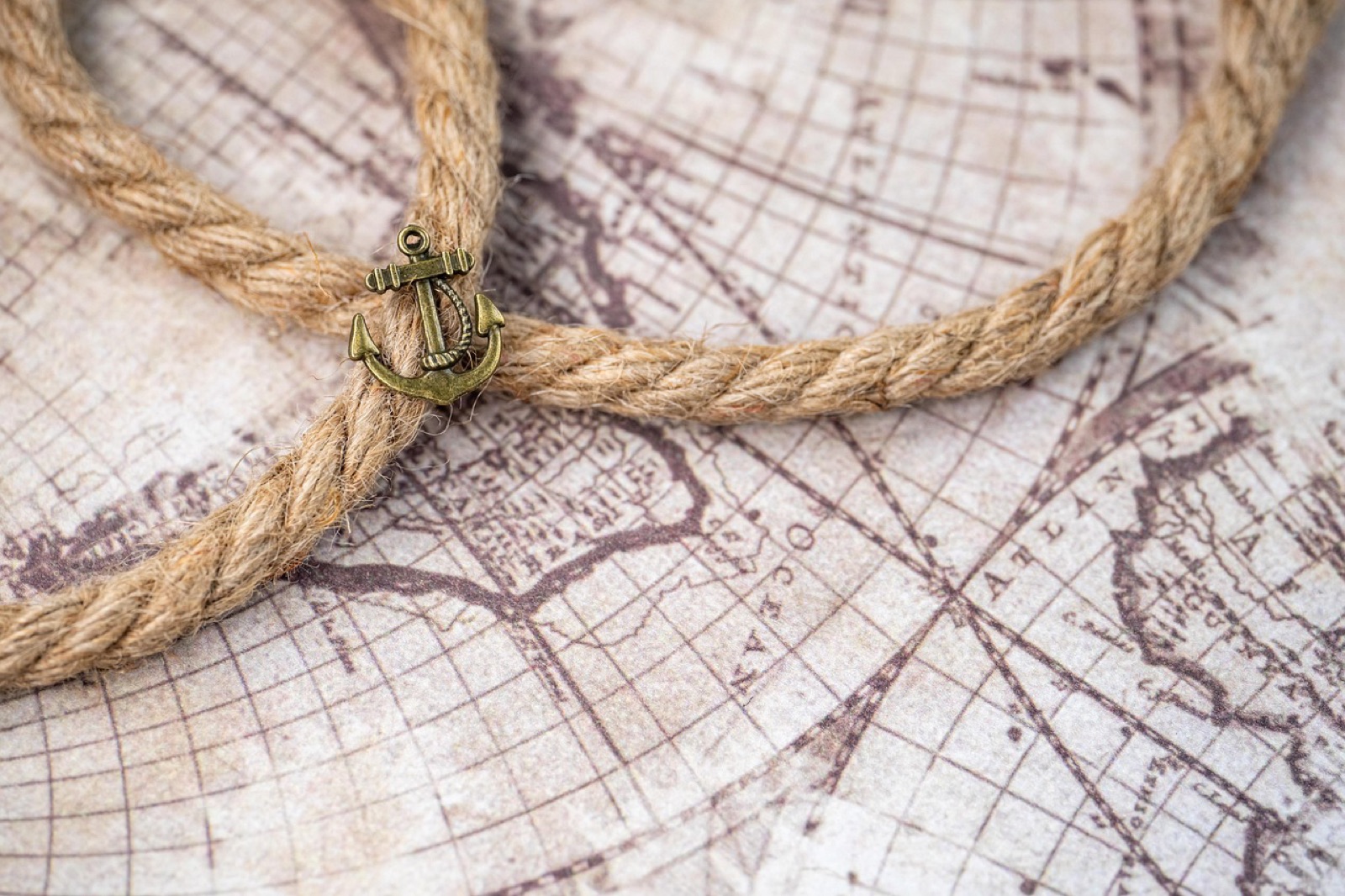 Coiled rope resting on an antique world map